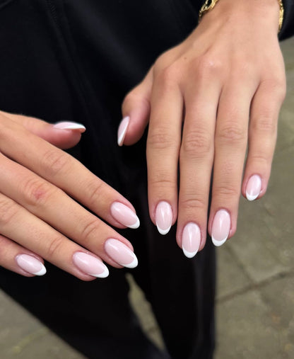 White French almond-shaped manicure shown on both hands